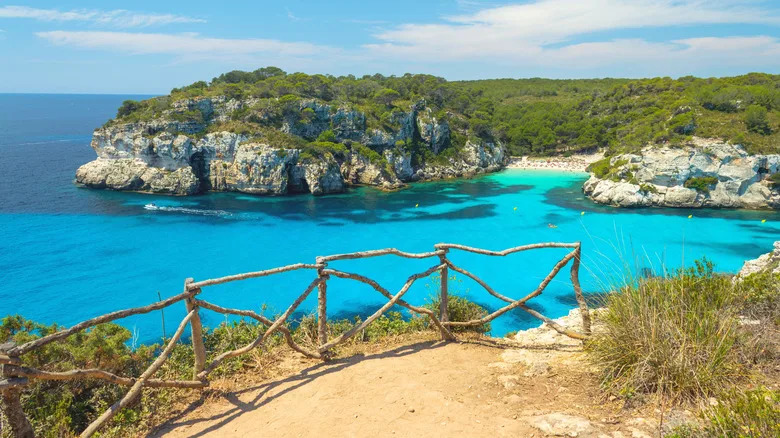 View from a sandy walkway on a cliff over Cala Macarelleta cove in Portugal