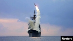 A Tomahawk Land Attack Missile (TLAM) is launched from the guided missile cruiser USS Cape St. George, in 2003.