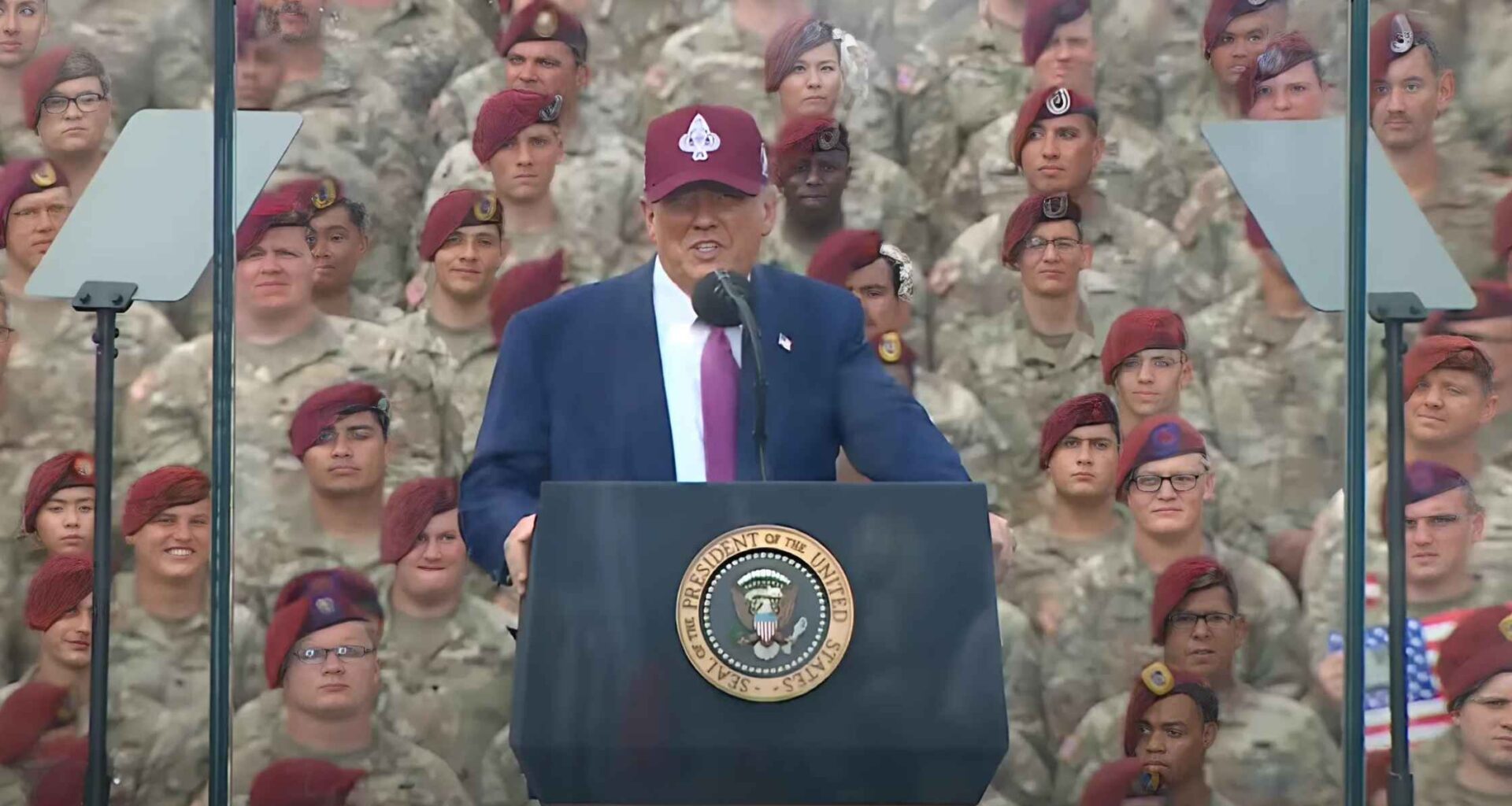 Donald Trump speaks and gestures to troops.