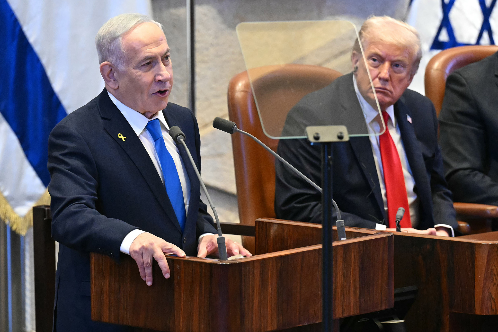 Le président américain Donald Trump écoute le Premier ministre israélien Benjamin Netanyahu s’adresser au parlement israélien, la Knesset, à Jérusalem le 13 octobre 2025, lors d’un sommet sur Gaza.