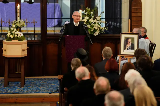 A man giving a eulogy at a funeral