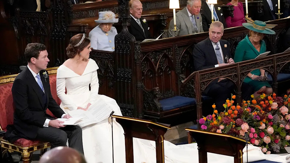 WINDSOR, ENGLAND - OCTOBER 12: Princess Eugenie and her husband Jack Brooksbank, look back towards the Duke of York and Sarah, Duchess of York (seated front) and Queen Elizabeth II, the Duke of Edinburgh, Prince of Wales, the Duke and Duchess of Cambridge, and the Duke and Duchess of Sussex, during their wedding at St George's Chapel in Windsor Castle on October 12, 2018 in Windsor, England. (Photo by Danny Lawson - WPA Pool/Getty Images)