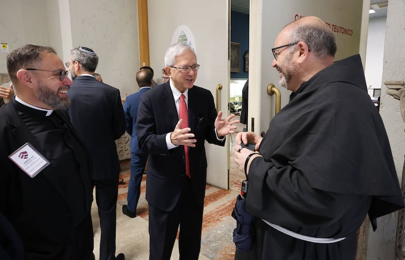 Elder Gerrit W. Gong of the Quorum of the Twelve Apostles of The Church of Jesus Christ of Latter-day Saints talks with Father Paolo Benanti, right, and Father John Paul Kimes during the Rome Summit on Ethics and Artificial Intelligence in Rome on Tuesday, Oct. 21, 2025.