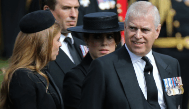 Prince Andrew smiling at Princess Beatrice, with Princess Eugenie in a black veiled hat behind them