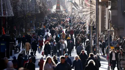 Getty Images Crowds of shoppers walking up and down Glasgow's Buchanan Street at Christmas time