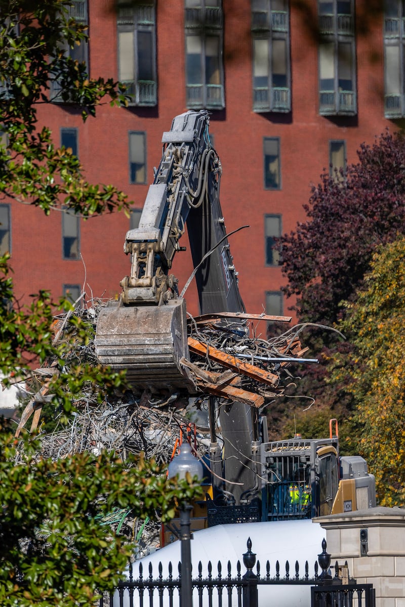 An demolition excavator works to clear rubble and twisted metal at the East Wing of the White House on October 24, 2025 in Washington, DC. The demolition is part of U.S. President Donald Trump's plan to build a multimillion-dollar ballroom on the eastern side of the White House.