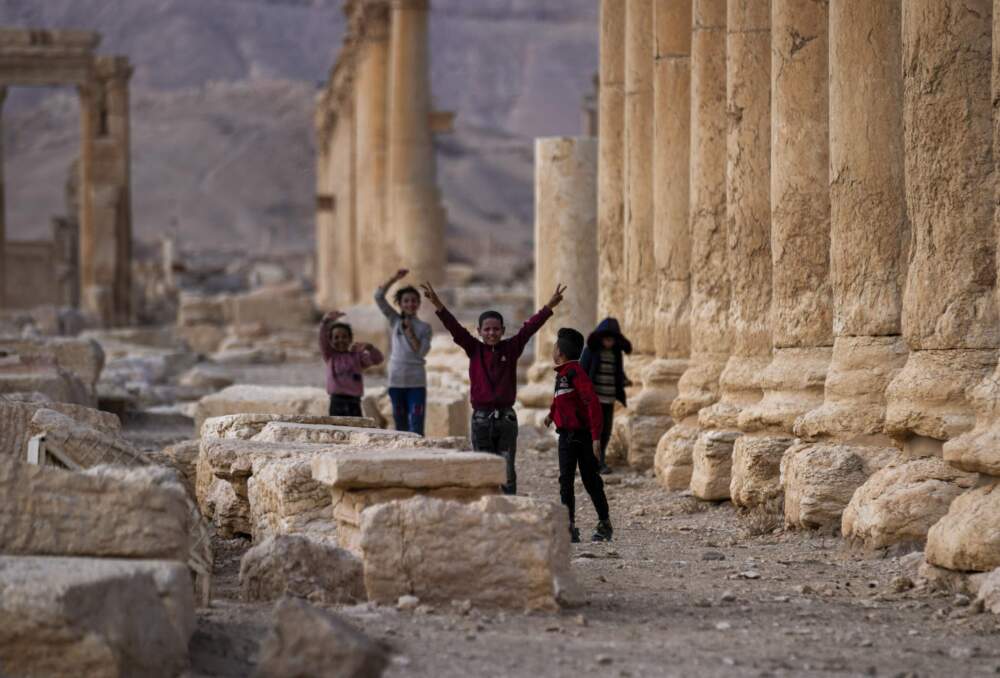 Children play, with one raising the V sign, at the ancient city of Palmyra, Syria, Saturday, Jan. 25, 2025. (Khalil Hamra/AP)