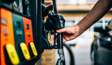 Gas pump with hand removing nozzle (WYDaily photo/Adobe)