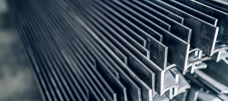 Stock image of a stack of long steel parts.