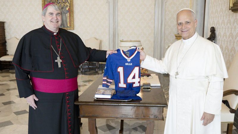 Bishop Mike and Pope Leo hold a Bills jersey