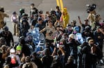Masked-up federal agents confront the protesters outside the U.S. Immigration and Customs Enforcement facility in Portland, Ore., on Sept. 28, 2025.