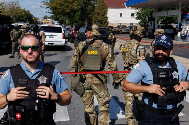 Chicago police create a barrier between federal agents and members of the community as people protest near the 3900 block of South Kedzie Avenue on Oct. 4, 2025, in Chicago's Brighton Park neighborhood. (Armando L. Sanchez/Chicago Tribune)