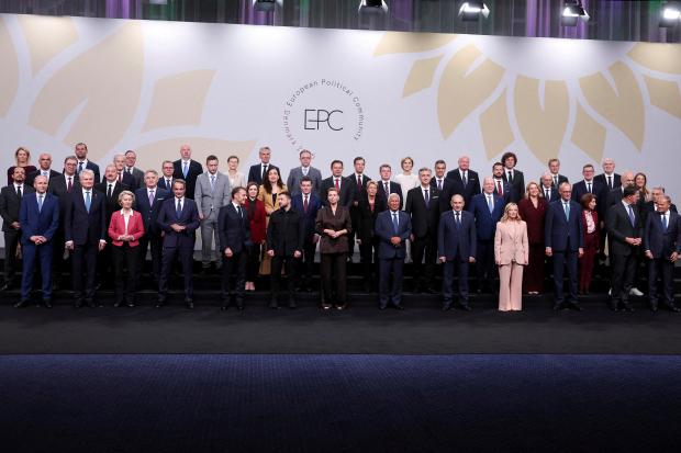 Ukrainian President Volodymyr Zelenskyy, front row center left, speaks to...