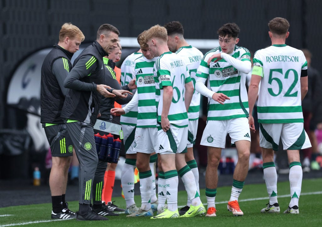 Stephen McManus, Head Coach of Celtic FC, speaks to his players during a drinks break during the UEFA Youth League 2024/25 match between Celtic FC and RB Leipzig at Lesser Hampden