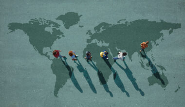 Group of young adults, photographed from above, on various painted tarmac surface, at sunrise.