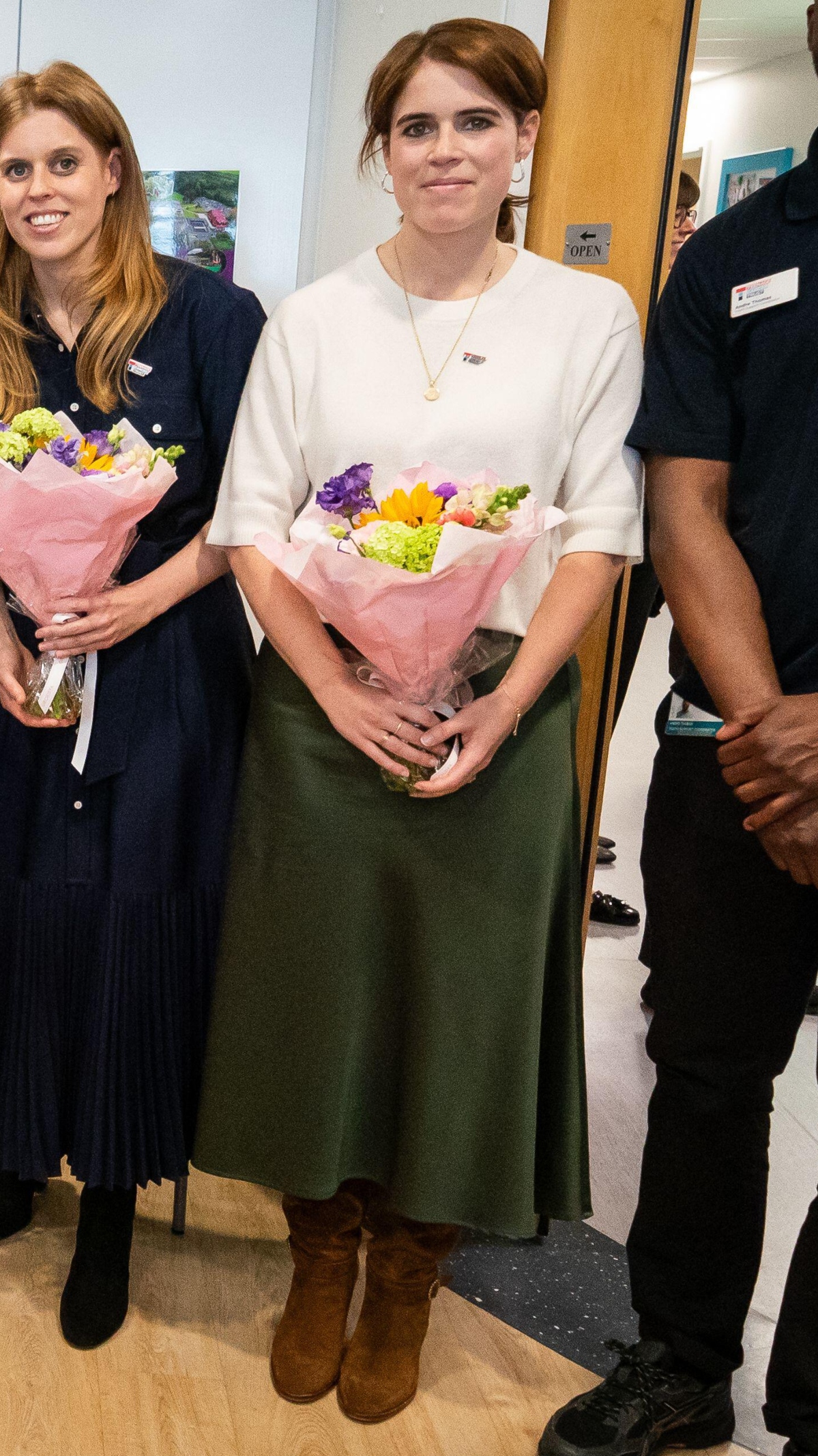Princess Eugenie holds flowers during a visit to the Teenage Cancer Trust unit