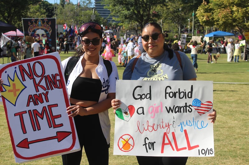 Two women with protest signs.