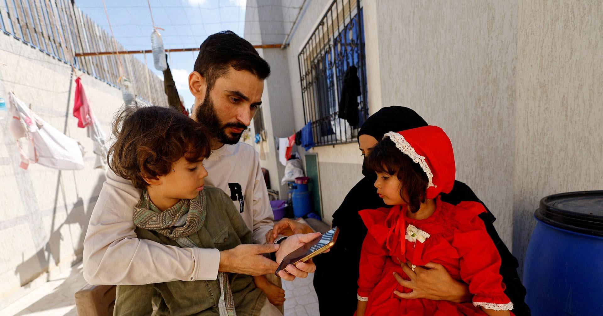 Freed Gaza photographer overjoyed to find family alive after being told in Israeli jail they were dead