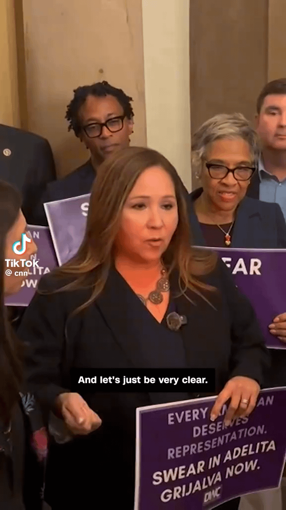 Arizona Rep-elect Adelita Grijalva and dozens of House Democrats marched to Speaker Mike Johnson’s office demanding she be sworn in. Once seated, Grijalva would become the 218th vote needed to force a bipartisan move to release the full Jeffrey Epstein case files.