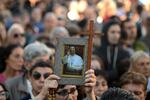 A woman holds a photo of Pope Francis in front of the Buenos Aires Cathedral on April 26, 2025, before a mass to bid him farewell. 