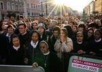 Attendees and nuns stand in the street as they wait before late Pope Francis' funeral ceremony.