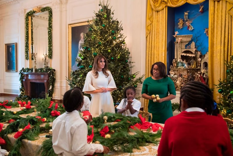 US First Lady Melania Trump makes Christmas garland with children in the East Wing as she tours holiday decorations at the White House in Washington, DC, November 27, 2017.
