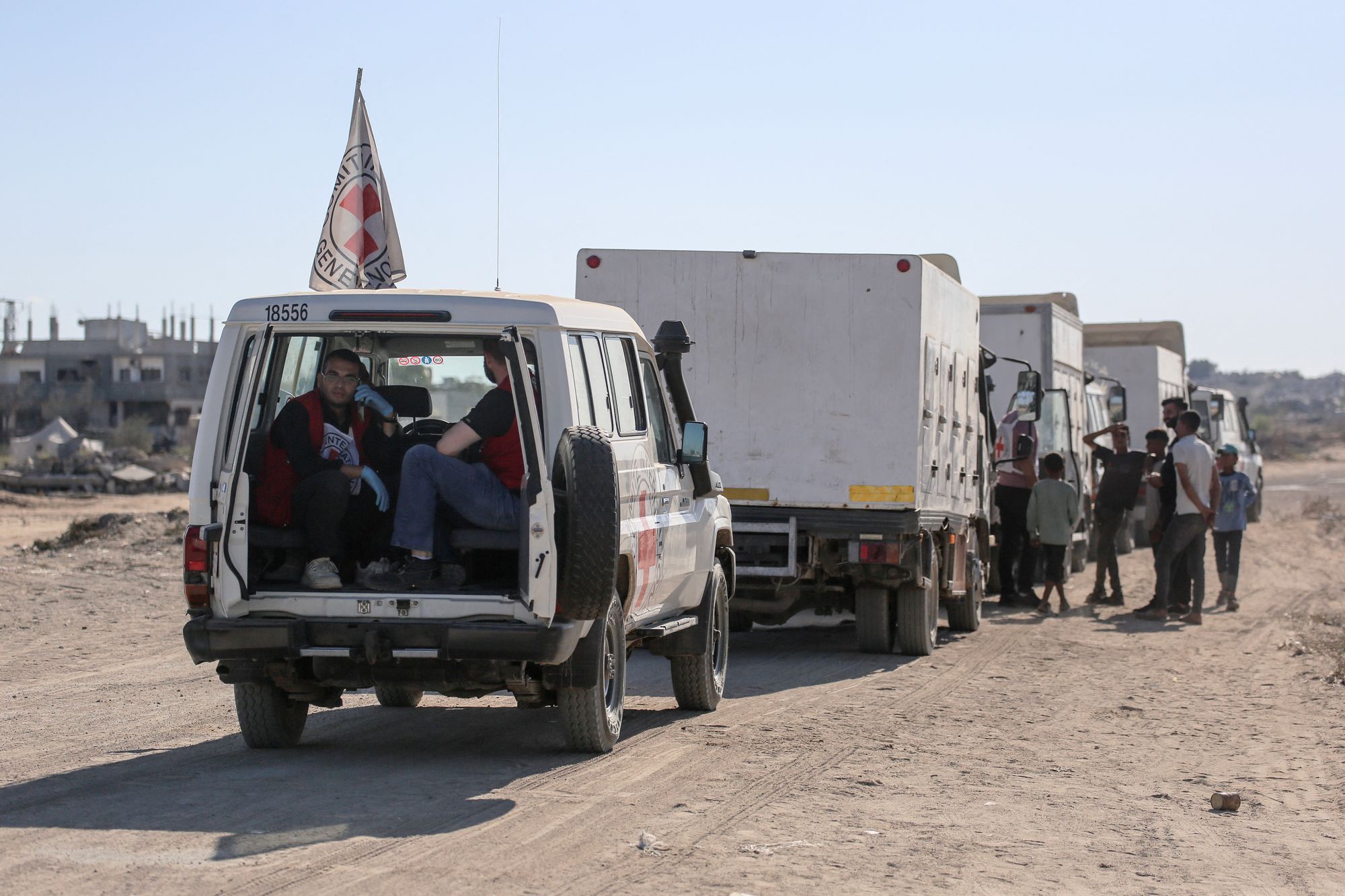 Vehicles of the International Committee of the Red Cross (ICRC) head for the Kissufim crossing to receive the bodies of Palestinians that have been held in Israeli custody, on October 15