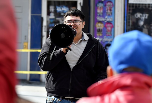 Purdue University Northwest student Rafael Manzo Jr. speaks to the crowd gathered along Indianapolis Boulevard during anti-ICE protests outside Each Chicago City Hall in East Chicago, Indiana, Saturday, Oct. 11, 2025. (Andy Lavalley/for the Post-Tribune)