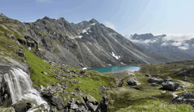 The northern lights shine bright behind a private jet Airbnb in Alaska.
