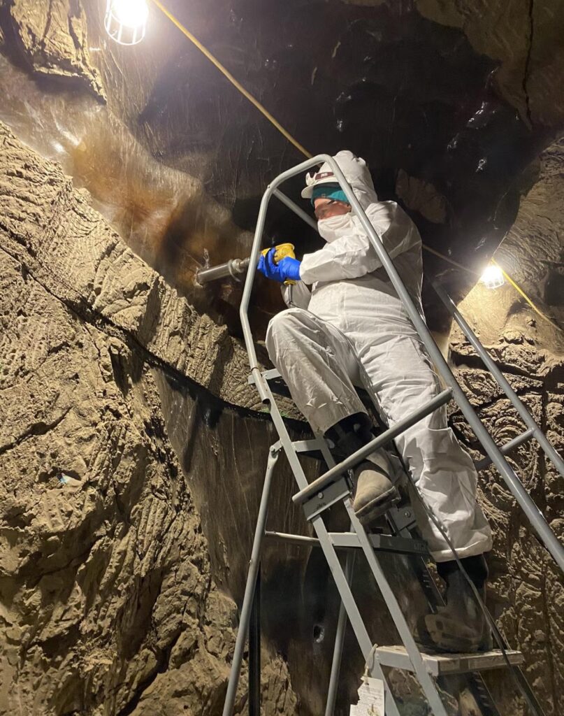 A researcher drilling into permafrost for an ice core