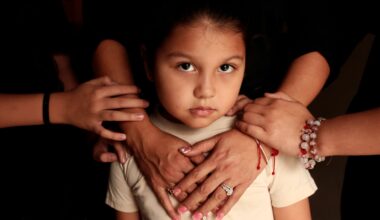 A girl, 5, stands for a portrait with her mother and sisters at their home in Leominster, Mass. last month after ICE agents arrested their father.