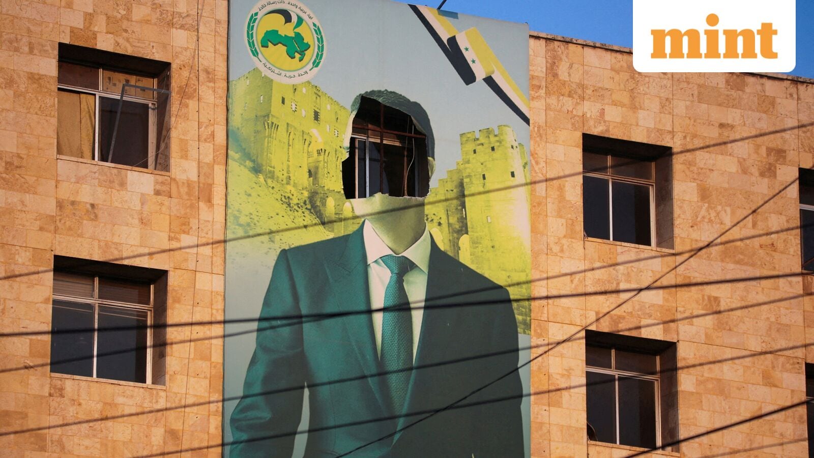 REUTERS PICTURES 40th ANNIVERSARY COLLECTION:  A view shows a damaged poster of Syria's President Bashar al-Assad in Aleppo, after the Syrian army said that dozens of its soldiers had been killed in a major attack by rebels who swept into the city, in Syria November 30, 2024. REUTERS/Mahmoud Hassano