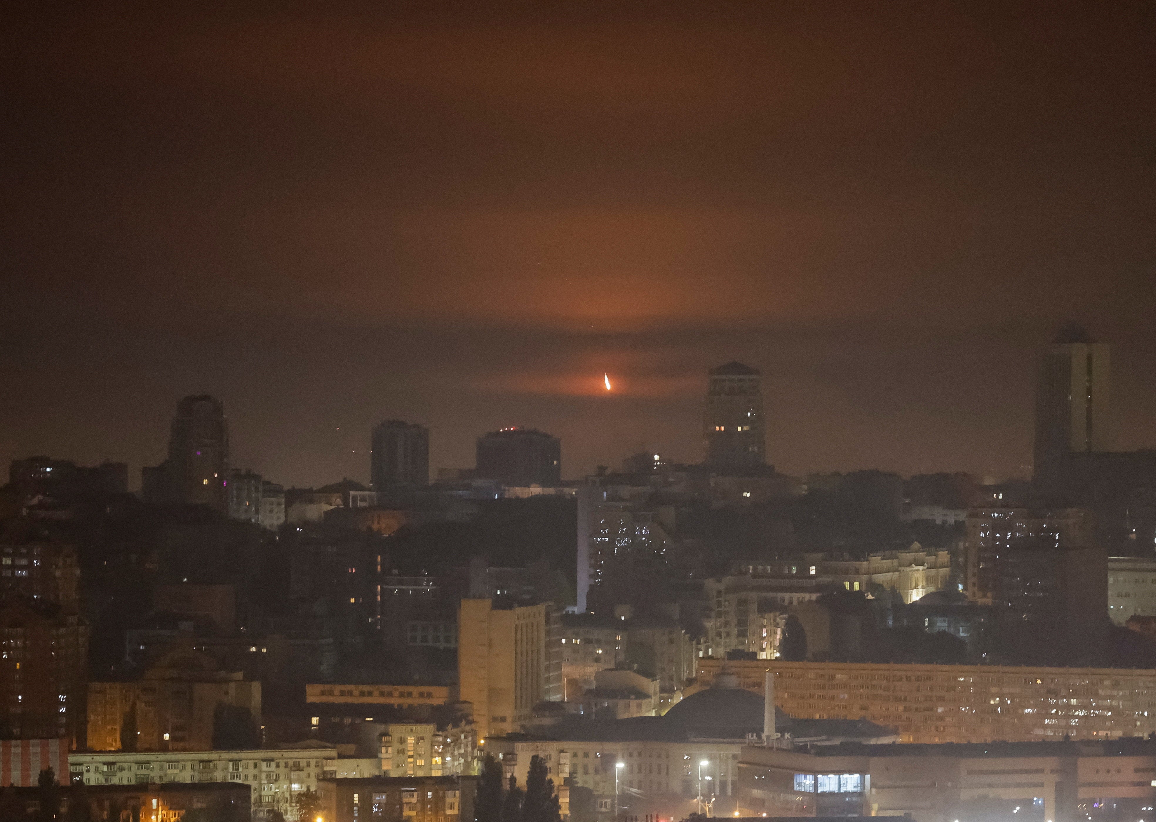 An explosion of a drone is seen in the sky over the city during a Russian missile and drone strike in Kyiv
