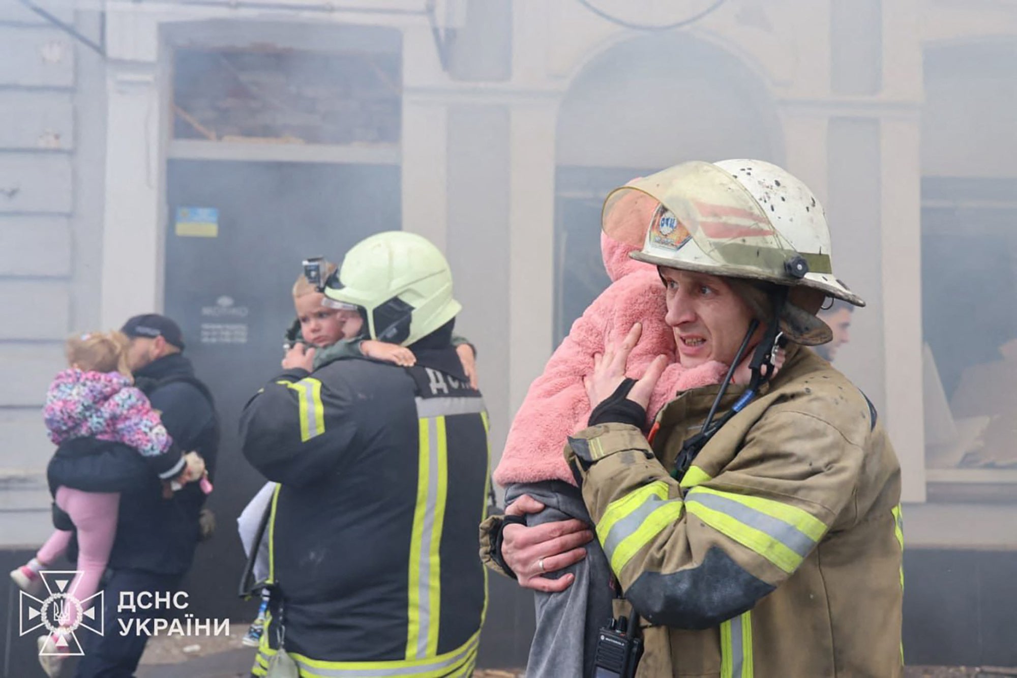 Rescuers evacuate children following a drone attack that hit a kindergarten in Kharkiv, Ukraine on Wednesday