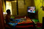 A Catholic man watches a live telecast of the funeral for the late Pope Francis taking place at St Peter's Square in the Vatican, in Colombo.