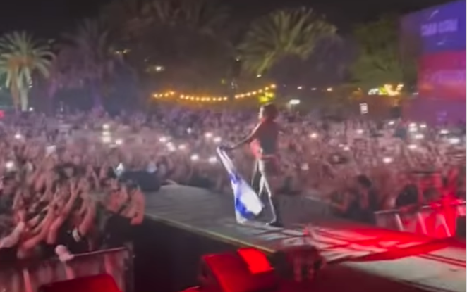 Rapper Azealia Banks performs in Tel Aviv, draped in Israeli flag