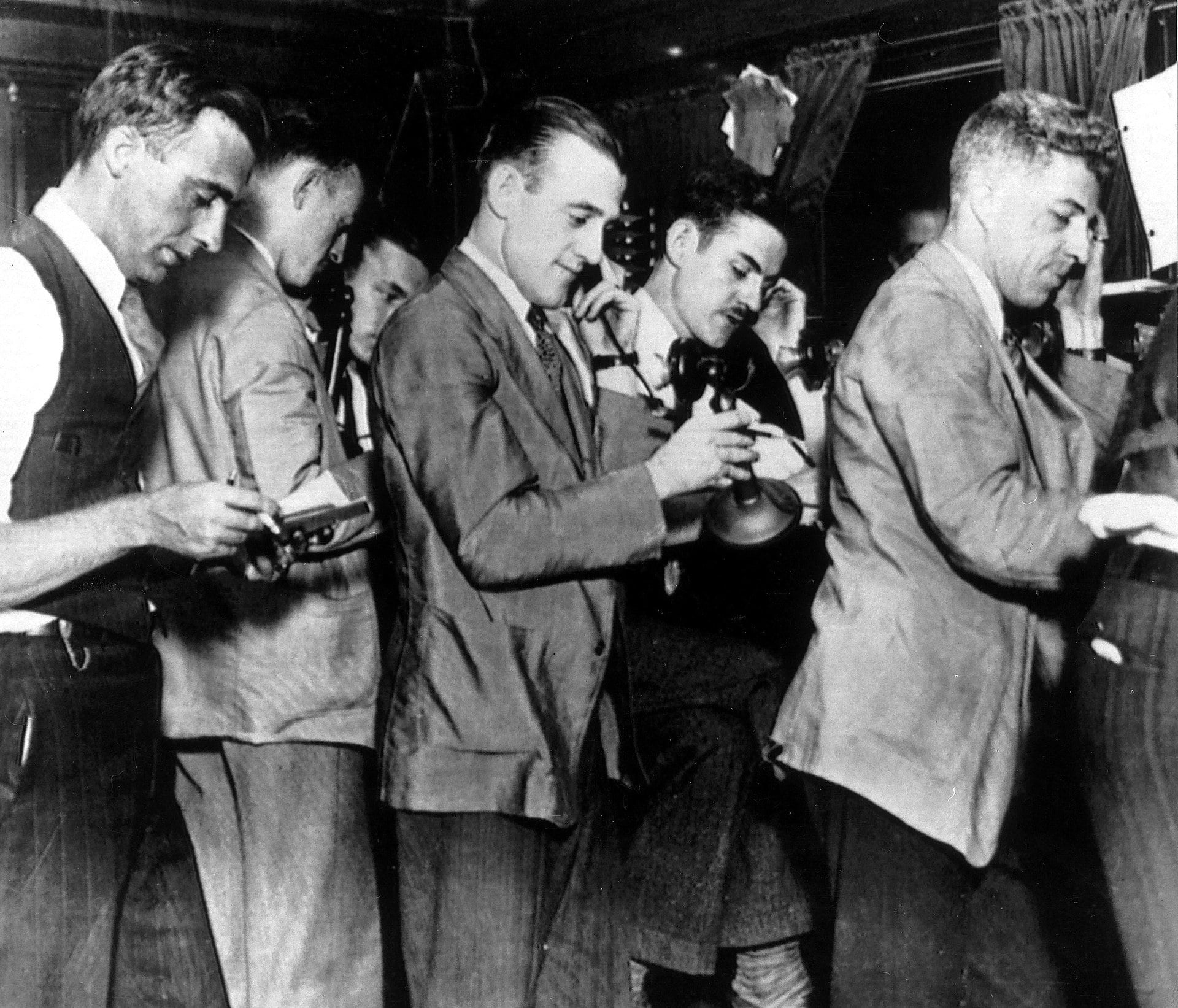 Stock brokers are seen at the stock exchange in New York, USA