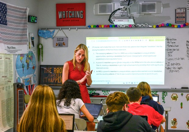 History teacher Amy Miller instructs eighth grade students on how...