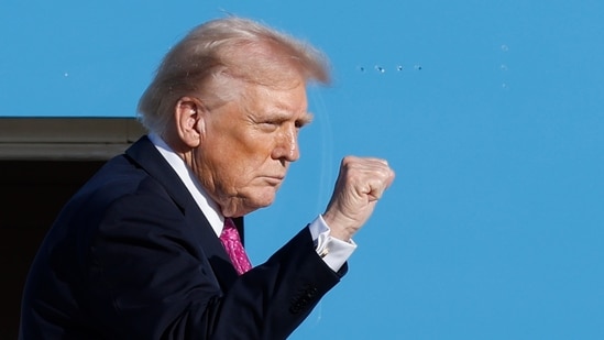 President Donald Trump gestures from the stairs of Air Force One as he boards upon his arrival at Joint Base Andrews(AP)