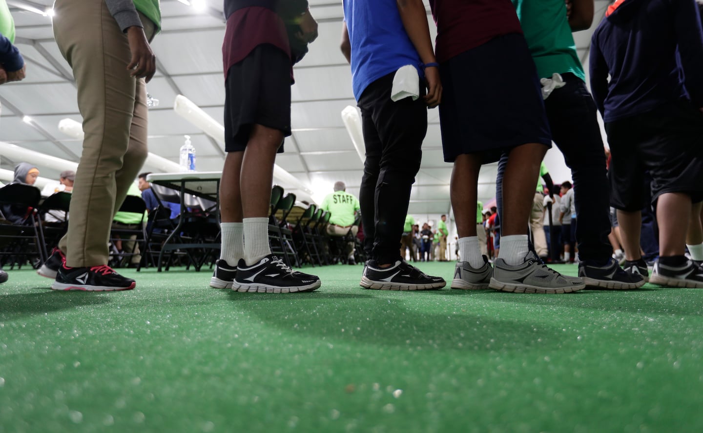 Immigrants lined up in the dining hall at a new US government holding center for migrant children in Carrizo Springs, Texas in 2019.