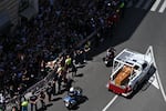 People gather along the road as the coffin of late Pope Francis is transported from St Peter's Basilica to Santa Maria Maggiore Basilica during the funeral ceremony in Rome on April 26, 2025. (Photo by Piero CRUCIATTI / AFP) (Photo by PIERO CRUCIATTI/AFP via Getty Images)