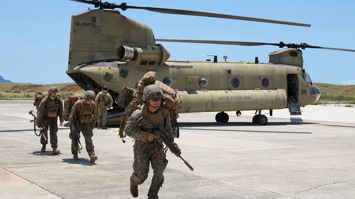 U.S. troopers alight from a U.S. Army CH-47 carrying American and Philippine troops