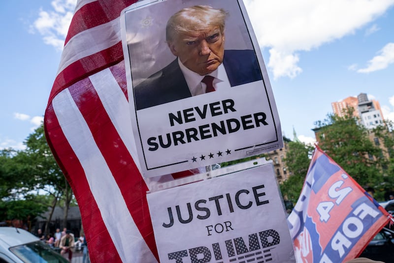 NEW YORK, NEW YORK - MAY 30: A poster of former President Donald Trump is held by one of his supporters after he was found guilty on all counts at Manhattan Criminal Court on May 30, 2024 in New York City. Donald Trump was found guilty on all 34 felony counts of falsifying business records in the first of his criminal cases to go to trial.