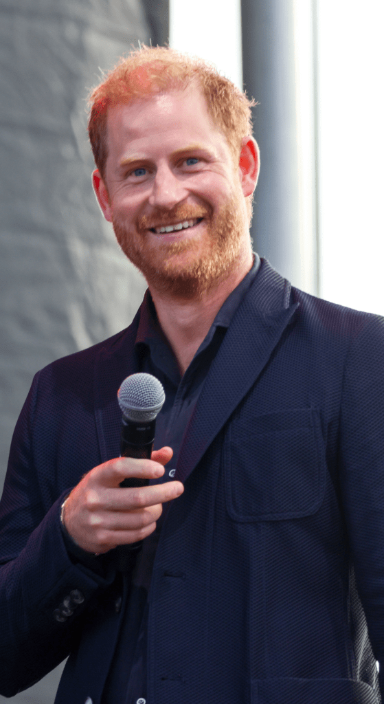 Prince Harry holding a microphone