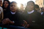 Two nuns look on as people gather during the funeral of Pope Francis in St. Peter’s Square.