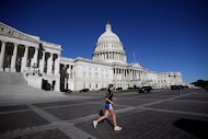 A person runs on the East Front of the U.S. Capitol, Friday, Oct. 17, 2025, in Washington. 