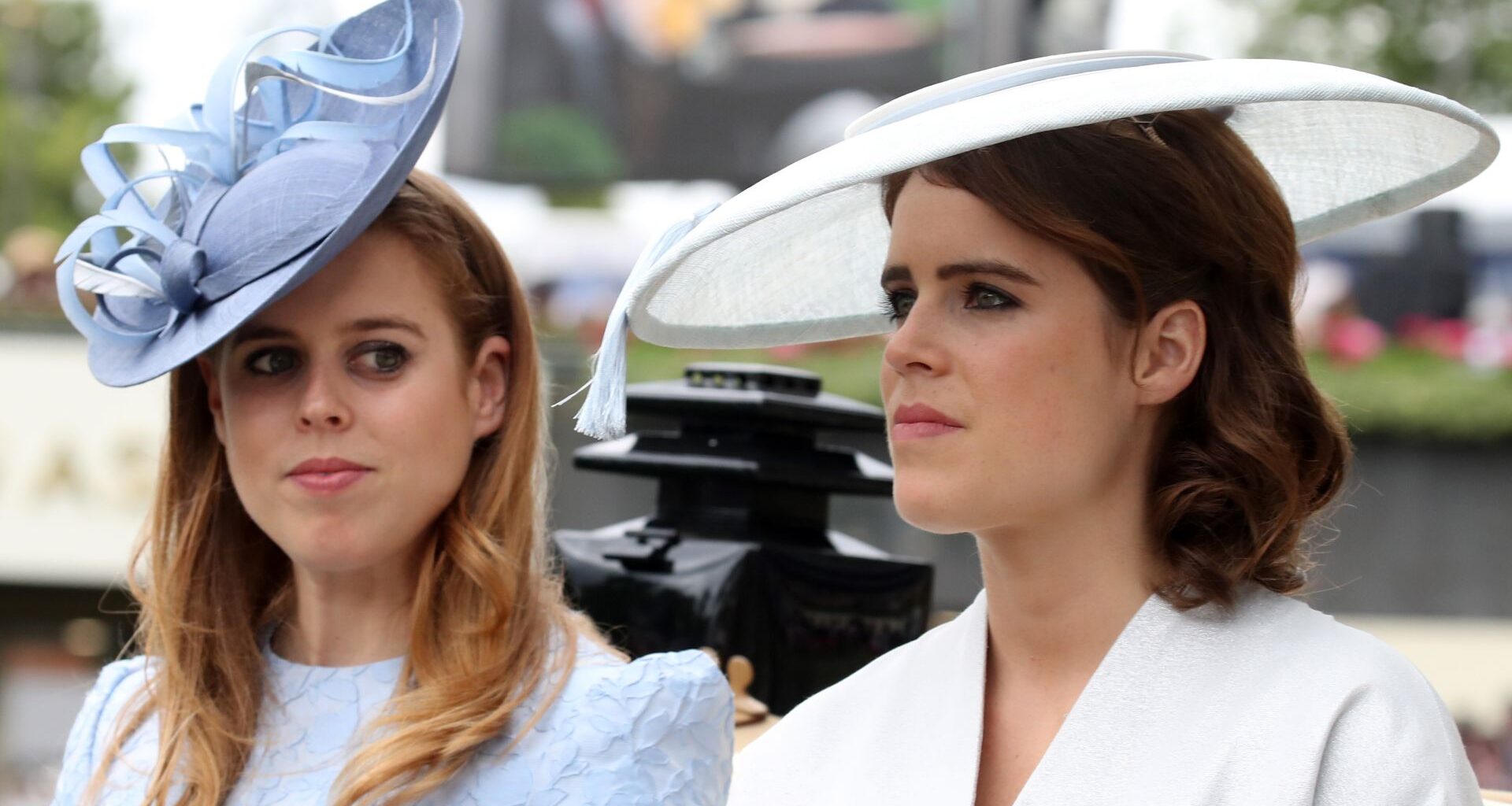 Princess Beatrice wears a baby blue hat and dress and sister Princess Eugenie wears a white hat and matching jacket