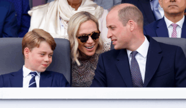 Prince George smirking as Zara Tindall leans over and talks to Prince William