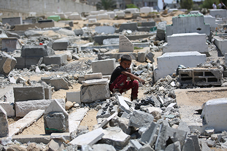 Palestinians, including children inspect the site after an Israeli airstrike severely damaged the Al-Ansar Mosque and partially destroyed the surrounding cemetery in Deir al-Balah, located in the central Gaza Strip on June 03, 2025. (Photo by Hassan Jedi/Anadolu via Getty Images)