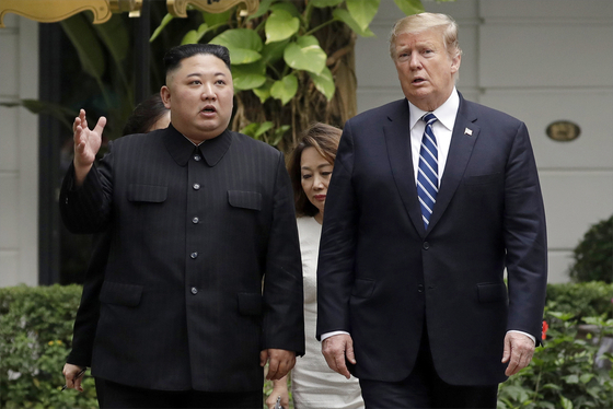 U.S President Donald Trump, right, and North Korean leader Kim Jong-un take a walk after their first meeting at the Sofitel Legend Metropole Hanoi hotel, in Hanoi, Vietnam on Feb. 28, 2019. [AP/YONHAP]